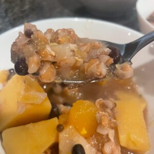 A white bowl filled with pumpkin lamb stew.