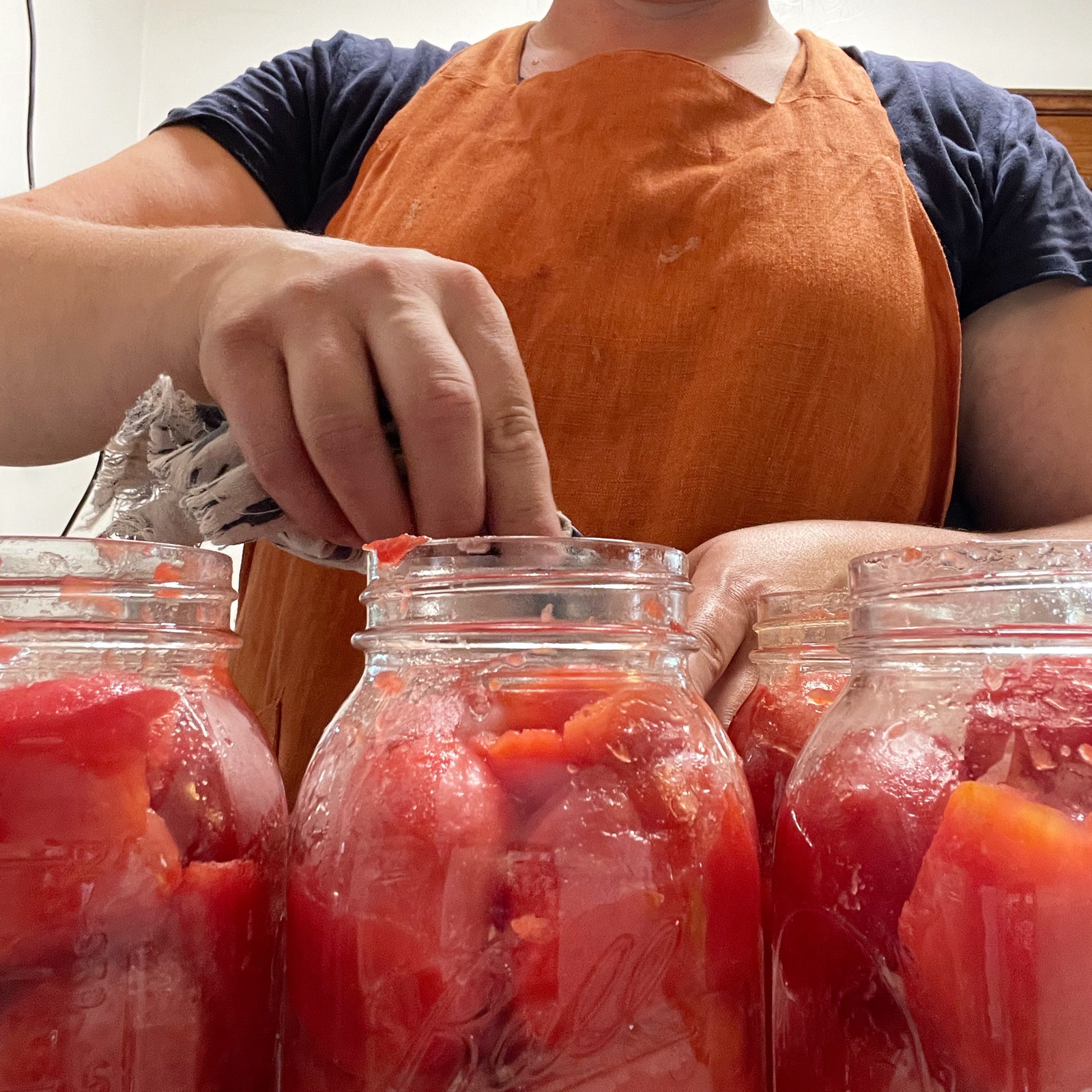 Jars of canned tomato slices.